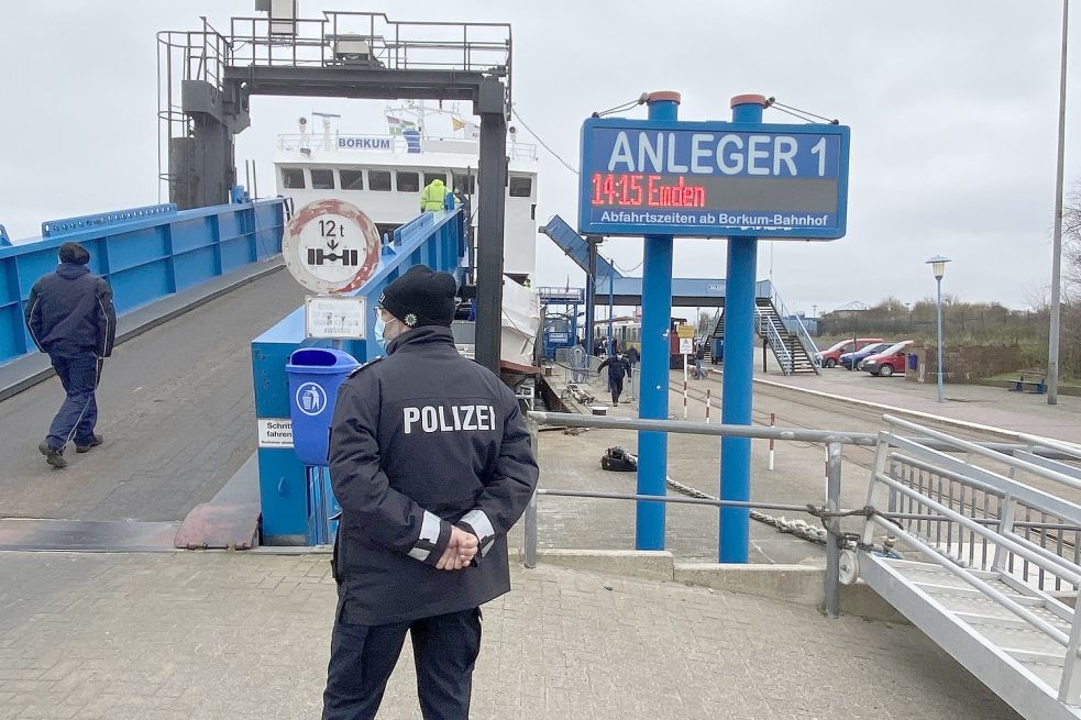 Ein Beamter der Polizei Borkum ist direkt an der Ausfahrt und deligiert die einfahrenden Kraftfahrzeuge.