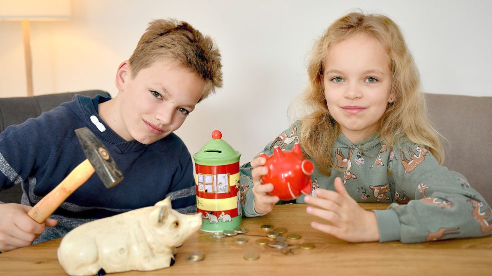 Henrik und Riena haben volle Spardosen, die zum Weltspartag ausgeleert werden sollen. Foto: Stromann