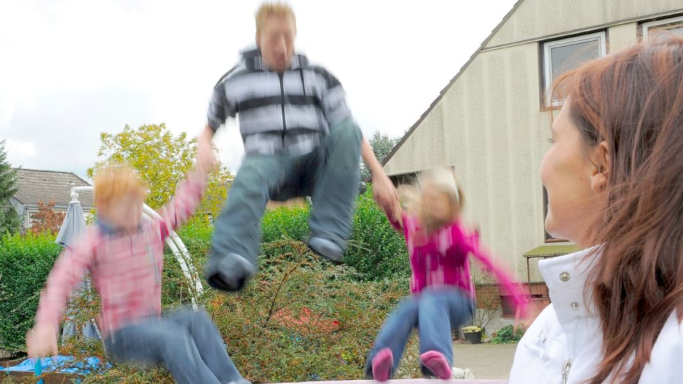 Pflegeeltern spielen mit zwei Kindern, die sie bei sich aufgenommen haben. Foto: Steffen/dpa
