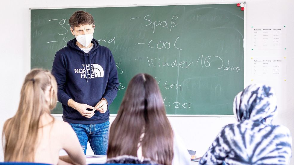 Thomas Thor ist Leiter der Fachstelle Schulvermeidung der Arbeiterwohlfahrt (Awo) Region Hannover. In dieser gestellten Szene spricht er vor einer Schultafel stehend mit Schulvermeidern. Foto: Frankenberg/DPA