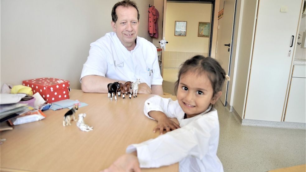 Beim Spielen auf der Kinderstation im Marien-Hospital huscht Mutahera kurz ein Lächeln übers Gesicht (im Hintergrund Chefarzt Dr. Thomas Klapperich). Foto: Schade