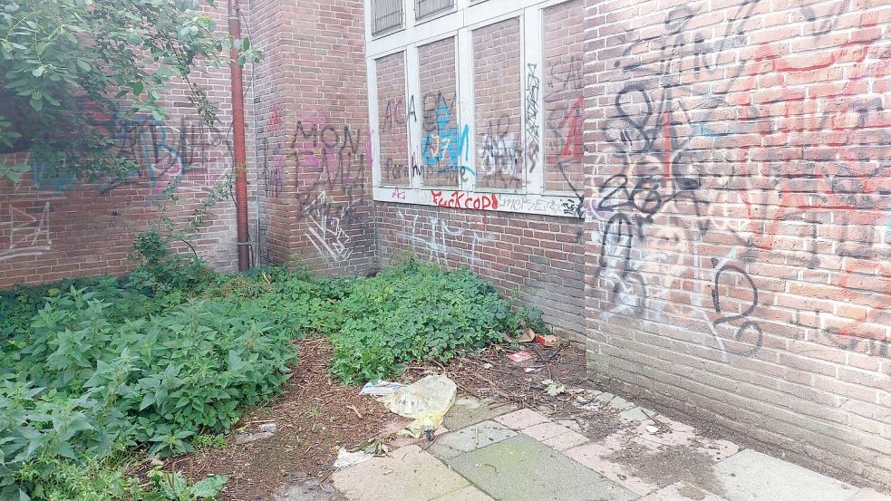 Auf der Rückseite der Kirche wurde die Wand mit Graffiti beschmiert, überall liegt Müll. Der Bereich ist noch nicht abgesperrt. Foto: Hanssen