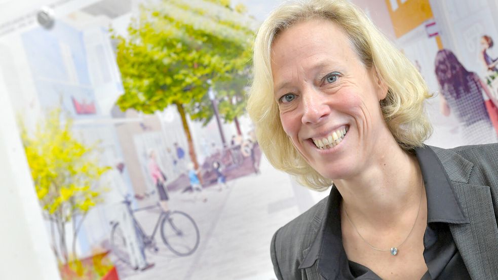 Das Foto zeigt Stadtbaurätin Alexandra Busch-Maaß kurz nach Dienstantritt im Januar 2022 in ihrem Büro im Auricher Rathaus vor einem Bild der Fußgängerzone. Foto: Archiv/Ortgies