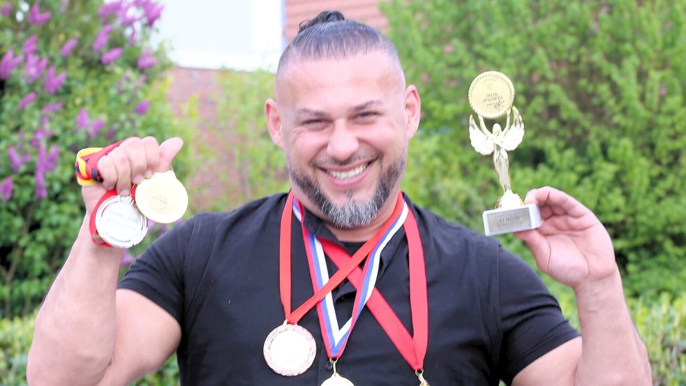 Der Wiesmoorer Safet „Sajo“ Kurtaj mit einigen der neuesten Medaillen aus diesem Jahr. Im nächsten Jahr, 2026, will er die Meisterschaft in den Norden Deutschlands holen. Foto: Nicole Böning